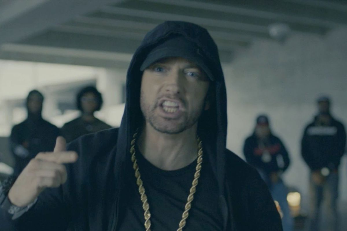 eminem wearing a black hoodie and gold chain